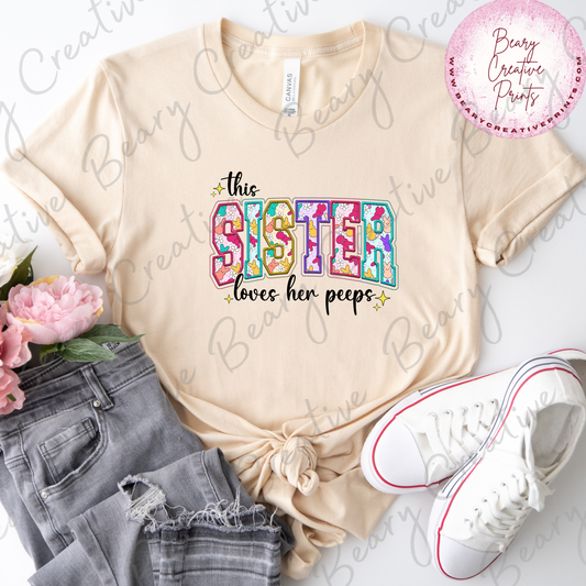 This Sister Loves Her Peeps on a Cream Unisex T-shirt